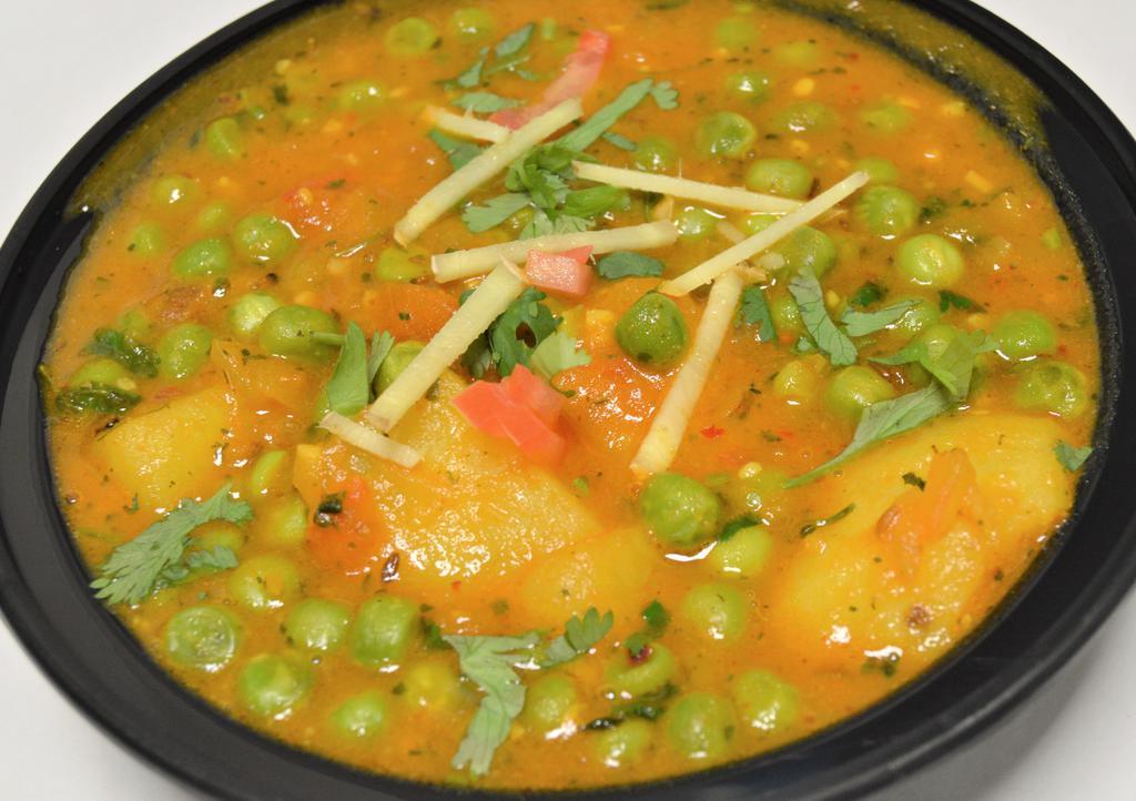 Aloo Mutter & Rice · Vegetarian. Green peas cooked with potatoes, onion, tomatoes, ginger-garlic paste, cumin, coriander and spices.
