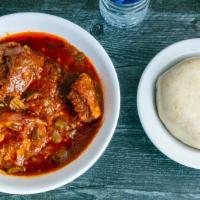 Banku & Okra Stew · Banku (Corn meal balled up) with Okro stew which includes  beef, tripes,crowfoot and  tilapia