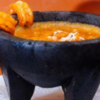 Molcajete Azteca · Tomatillo and red pepper sauce, served on a hot lava rock bowl, with chihuahua cheese, chori...