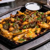 Texas Cheese Fries · Topped with Monterey & pepper Jack and cheddar cheese, applewood smoked bacon, jalapeños & g...