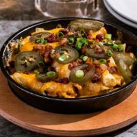 Half Order Texas Cheese Fries · Topped with Monterey & pepper Jack and cheddar cheese, applewood smoked bacon, jalapeños & g...