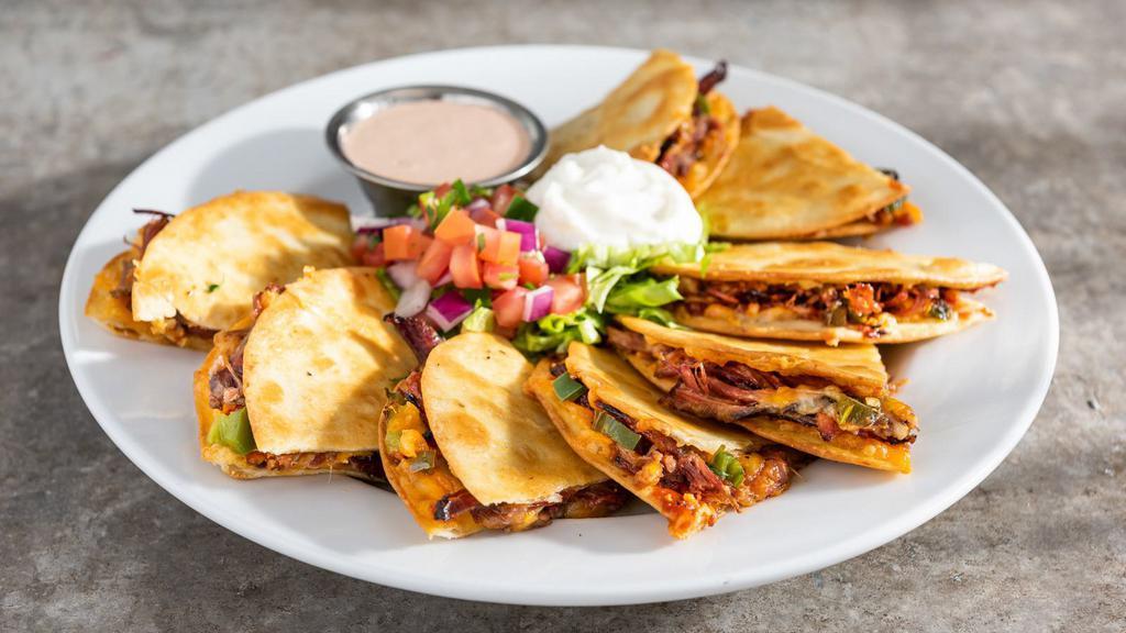 Brisket Quesadillas · Shredded cheese, slow-smoked pulled brisket, roasted jalapenos, house BBQ. Served with pico, sour cream and ancho-chile ranch. 1700 cal.