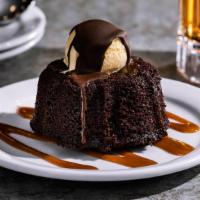 Molten Chocolate Cake · Favorite. Chocolate cake with a molten chocolate center, topped with vanilla ice cream in a ...