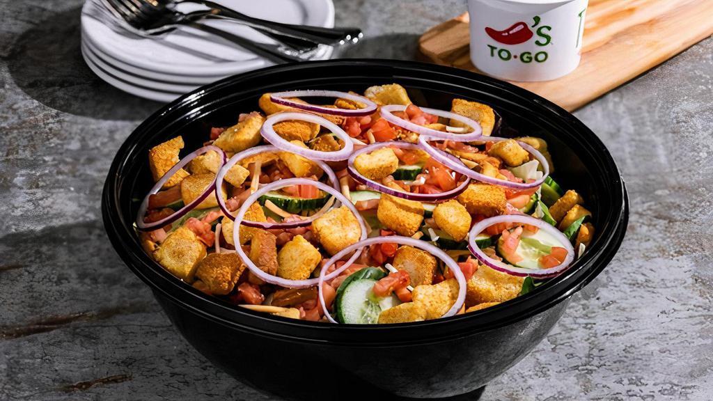 House Salad · Tomatoes, red onions, cucumbers, shredded cheese, and garlic croutons, with your choice of dressing.
