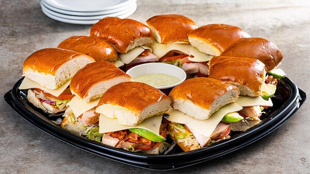 California Turkey Club · With turkey, applewood smoked bacon, avocado, swiss, tomatoes, onions, lettuce, and cilantro-pesto mayo on a toasted buttery roll. Serves up to eight. 5330 cal.