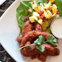 Buffalo Caribbean Chicken Tenders · hand-breaded and tossed with our addictive mango-buffalo bbq sauce served with pineapple- ja...