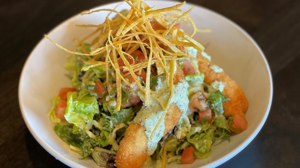 Crispy Southwest Chicken · romaine, mixed greens, grilled corn, shredded cheese, black beans and avocado tossed in creamy santa fe ranch, topped with
crispy chicken tenders, pico de gallo and tortilla strips
