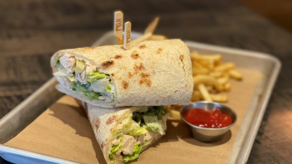 Chicken Caesar Wrap · grilled chicken, romaine lettuce and shaved romano in our lemon caesar dressing all rolled up in our freshly baked wrap.