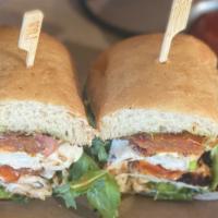 Chicken Caprese · grilled chicken with melted fresh mozzarella, marinated tomatoes, pesto aioli and arugula on...
