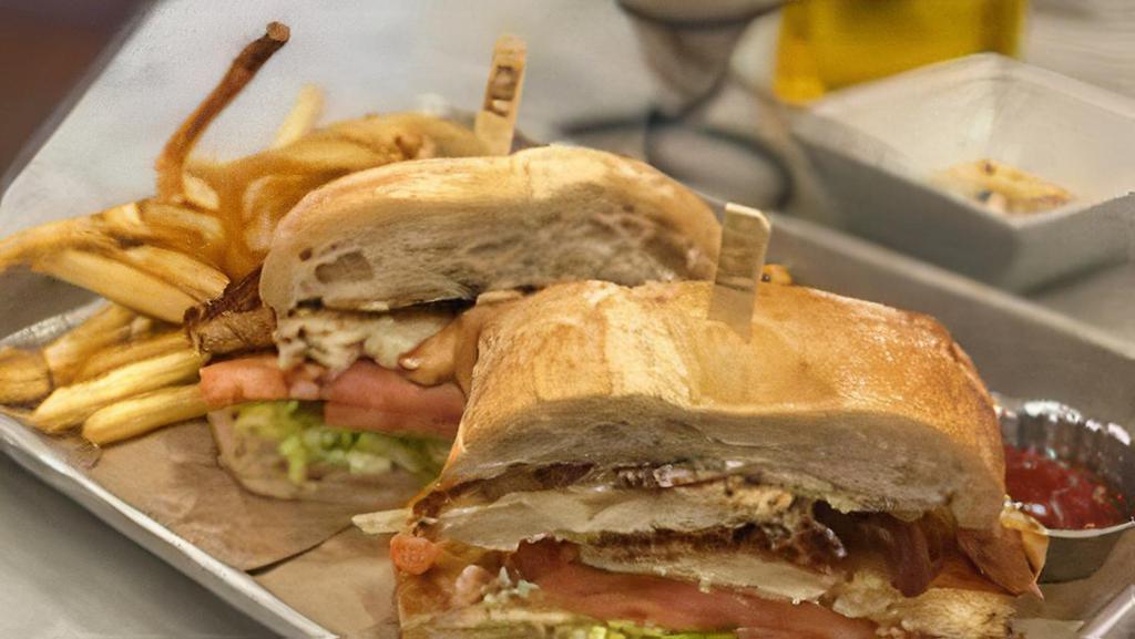 Mustard-Crusted Chicken Blt · mustard-marinated and panko crusted with country bacon, lettuce, tomato and lemon aioli on toasted ciabatta with coleslaw and fries.