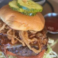 Smoky Joe Burger* · our classic burger with melted pepper jack, smothered with shredded bbq pork on a martin's p...