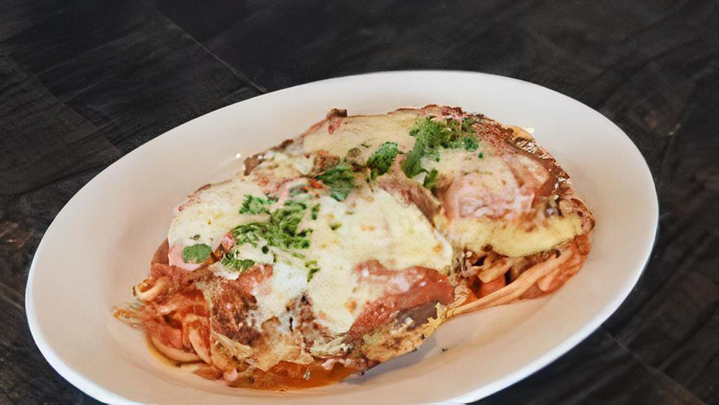 Chicken Parmesan · romano-crusted chicken, pan-seared and topped with melted mozzarella over linguini with house-made tomato sauce.