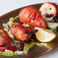 Tandoori Chicken · Tender chicken, marinated in yogurt and spices, baked on skewers in our tandoori oven. Serve...
