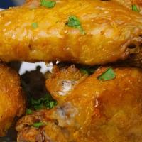 Coconut Curry Chicken Wings · Five per serving. Chicken wings marinated and roasted in guyanese curry sauce. Tossed in coc...