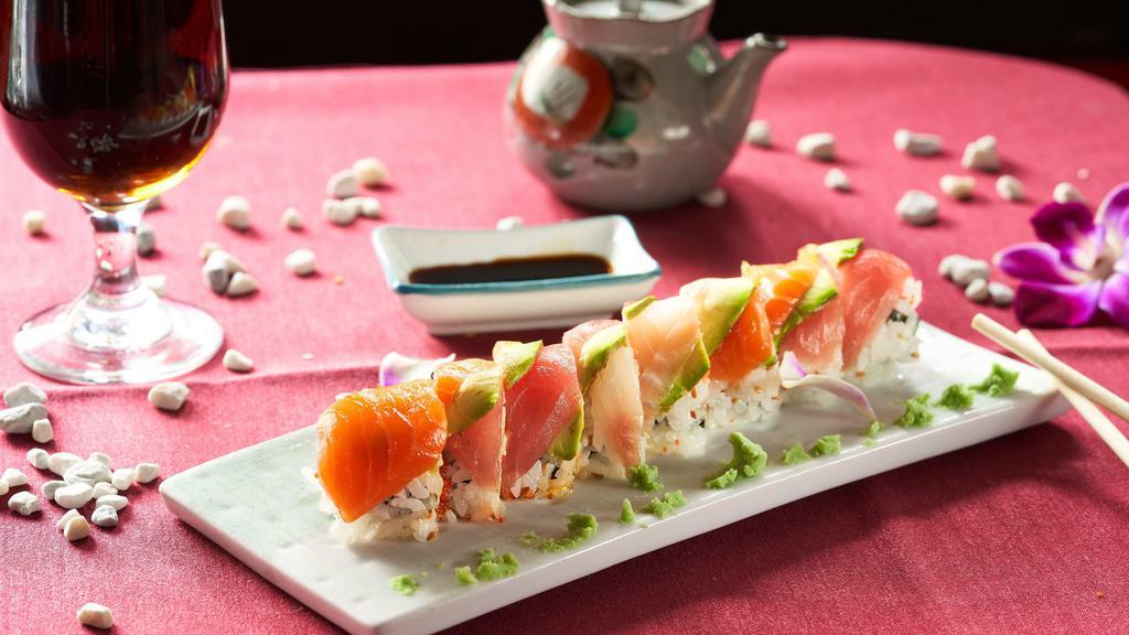 Rainbow Maki · Inside shrimp, crab stick, tobikko and spicy mayo, outside tuna, salmon, white fish, and avocado.