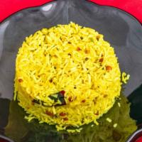Lemon Rice · Cooked rice mixed with lemon juice peanuts, peppers, and other herbs and spices.