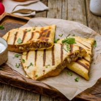 Grilled Chicken And Steak Quesadilla · Juicy grilled steak and grilled chicken with onions and peppers, salsa, sour cream and guaca...