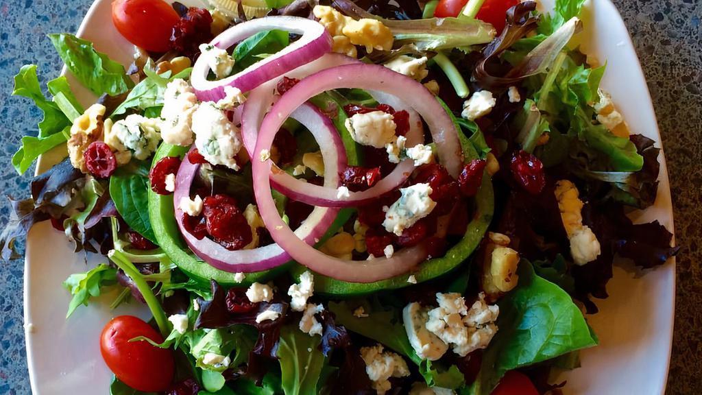 Salad Royal · Mix greens, tomatoes, sweet red onions, fresh peppers, dried cranberries, roasted walnuts and Gorgonzola cheese with honey vinaigrette.