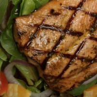 Salmon Salad · Herbed salmon filet over mix greens, tomatoes, olives red onions and orange pieces with fres...