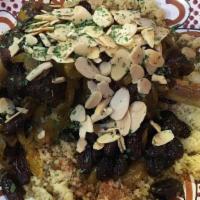 Mrouzia Almond Lamb · Braised tender Lamb shank with caramelized onions, raisins, Moroccan spices & roasted almond...
