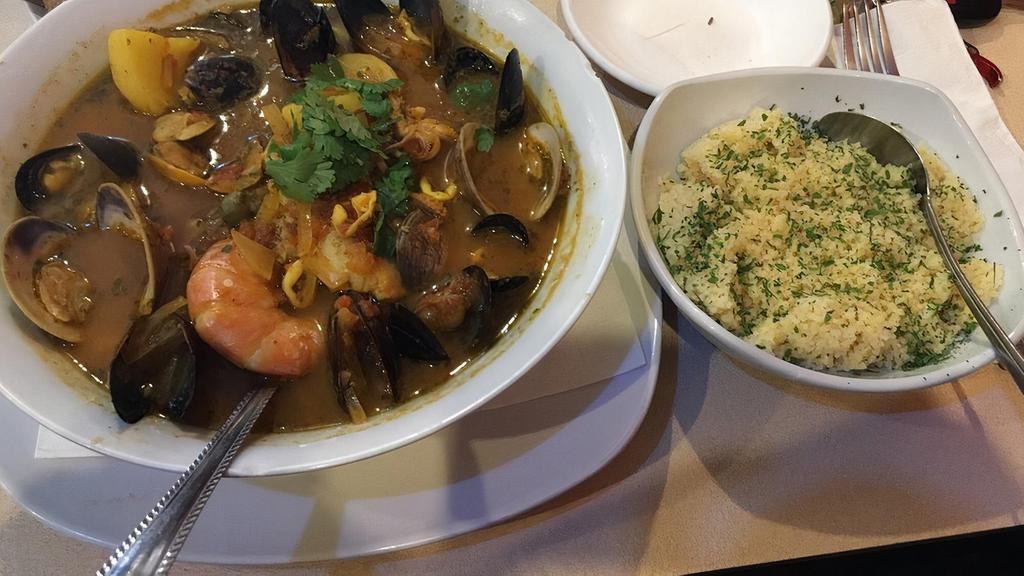 Sultan Seafood Stew · A king-size melange of fish, calamari, Mussels Clams, shrimps, diced potatoes in saffron & herbs broth, with a side of rice or couscous.