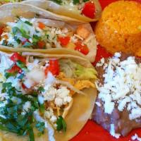 Tacos Mexicanos · Order of three corn tortilla tacos with onions, cilantro, and lime served with rice and bean...