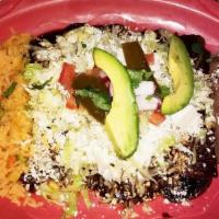 Enchiladas Poblanas · Soft rolled corn tortillas simmered in mole sauce, stuffed with your choice of chicken, carn...