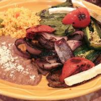 Carne Ranchera · Grilled steak with guajillo sauce, grilled tomatoes, grilled jalapeños, grilled onions, ques...