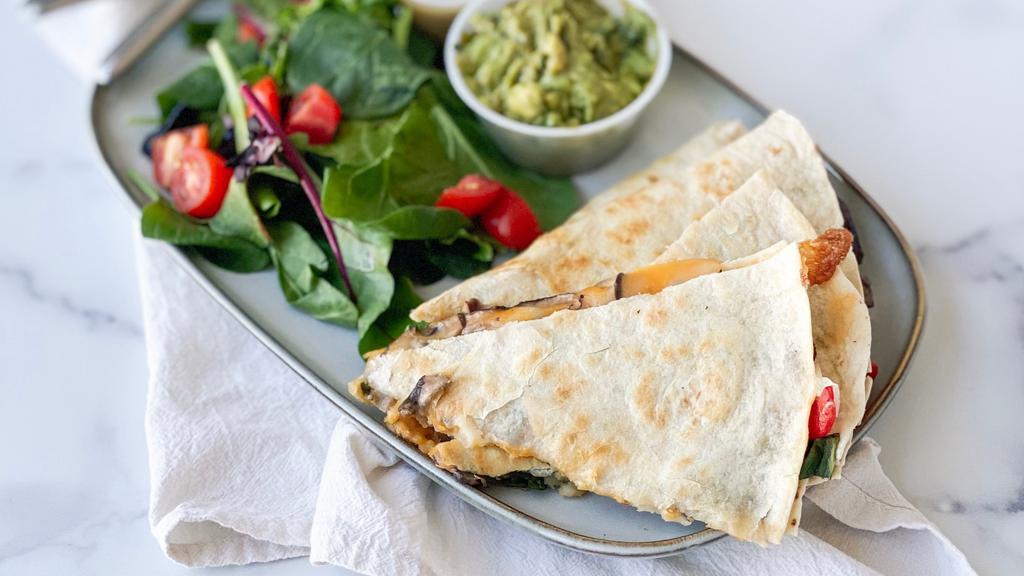 Spinach & Mushroom Quesadilla · Sauteed garlic spinach, roasted mushrooms, roasted red peppers, cheddar & mozzarella cheese in a pressed flour tortilla with side of guacamole & chipotle aioli. Served with a side salad.