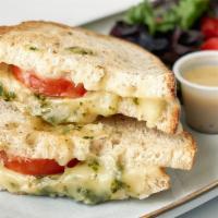 Fontina Grilled Cheese · Fontina cheese, sliced tomato, & MAMAmade basil pesto on grilled sourdough bread, served wit...