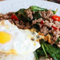 Pad Krapao · Stir fried your choice meat with basil, garlic and topped with egg sunny side up.