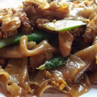 Pad Sa-Ew · Stir fried chow fun noodles prepared in sizzling wok served with egg, broccoli, carrot, onio...