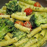 Creamy Pesto Pasta · housemade basil pesto, heirloom tomato, broccoli, pecorino romano, served over rigatoni