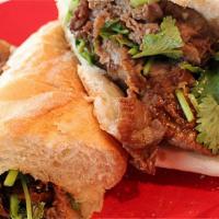Sizzling Beef Banh Mi · Sliced Beef with honey garlic sauce. Served with cucumber, cilantro, pickled radish, and car...