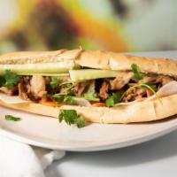 Seared Pork Belly Banh Mi · Marinated  pork belly seared with honey garlic sauce. Served with cucumber, cilantro, pickle...
