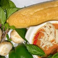 Spicy Chicken Curry Banh Mi · Shredded chicken marinated in a spicy red curry. Served on bread.