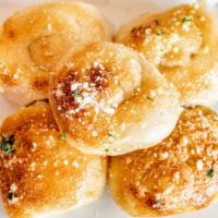 4 Garlic Knots · Our Pizza Dough Tied in a Knot, Baked and then Topped with EVOO, Fresh, Garlic, Lucatelli Ch...