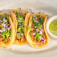 Pork Tacos · Corn taco tortilla, carnitas, queso fresco, diced red onions, cilantro, green sauce. Can be ...
