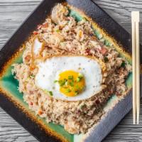 Crave Fried Rice · Fried rice with bacon, shrimp, ham and vegetables topped with a fried egg.
