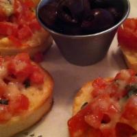 Tomato & Basil Bruschetta · Roasted roma tomatos, basil and italian herbs topped with parmesan cheese and baked on slice...
