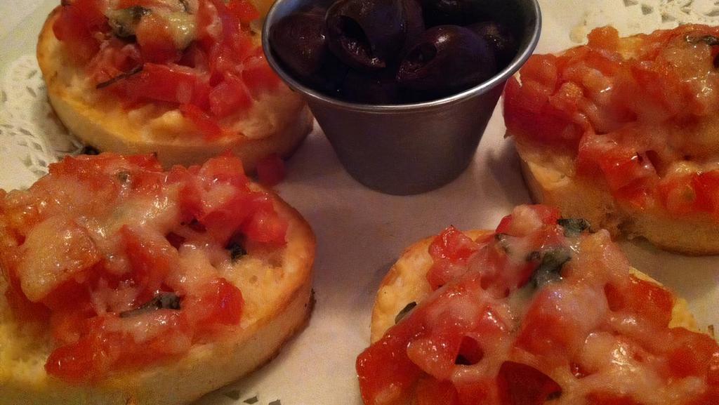 Tomato & Basil Bruschetta · Roasted roma tomatos, basil and italian herbs topped with parmesan cheese and baked on slices of bruschetta bread. served with kalamata olives on the side.