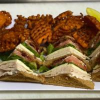 Turkey Club · House roasted turkey, American cheese, bacon, lettuce, tomatoes & mayo