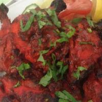 Tandoori Spring Chicken · Spring chicken marinated in a traditional tandoori masala and hung yogurt, skewered and cook...