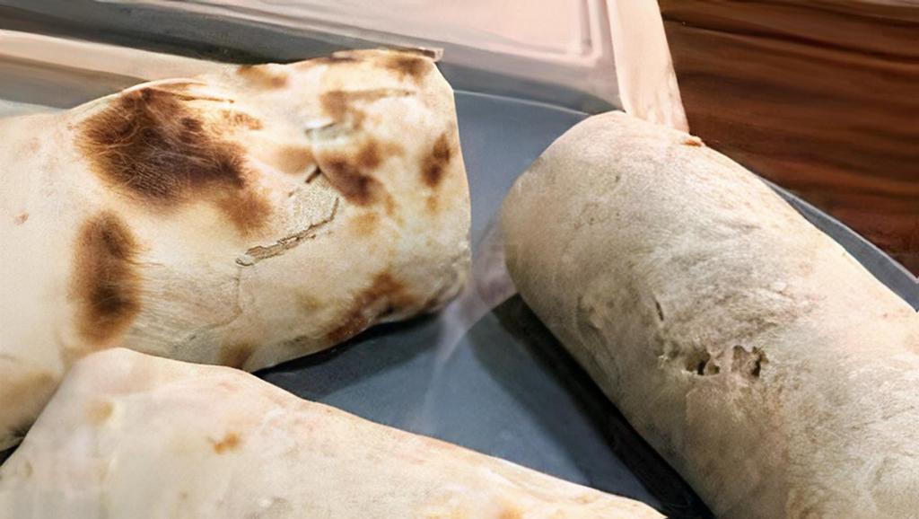 Chicken Fajita Burrito · Flour wrap with rice, black beans, pico de gallo, lettuce, sour cream and cheese and hot sauce on the side.