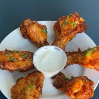 Thai Fried Chicken Wings · Tossed with Thai curry paste, lemongrass, brown sugar, soy sauce, and coconut milk.