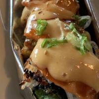 Mt. Sleeping Lady Roll · Baked roll, crab meat, avocado, cream sauce, cooked salmon, topped with sauce.