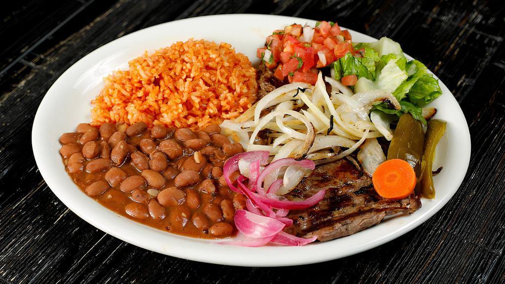 Carne Asada · Grilled steak. Served with rice, beans, salad, and two tortillas.