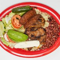 Churrasco Argentino · Steak served with hot sausage, rice, beans, salad, soft cheese and 2 tortillas.