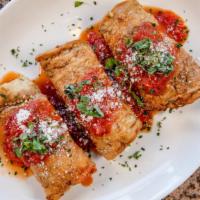 Eggplant Rollatini · Our homemade eggplant rolled with ricotta and baby spinach.