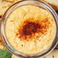 Hummus (Roasted Garlic Chickpea Spread) · Served with a pita bread.